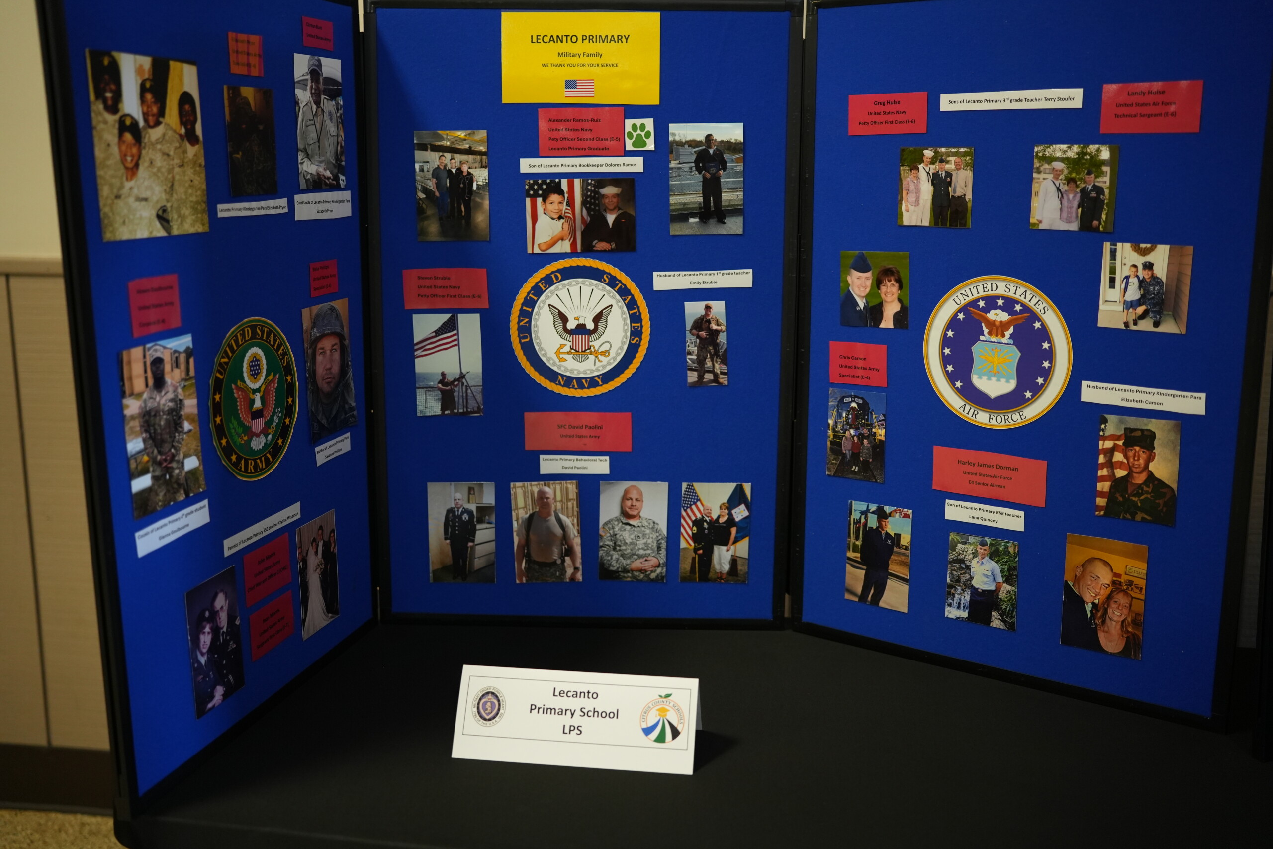 A trifold display board showcases photos and information about military families at Lecanto Primary.